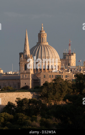 Valletta, St. John`s Co Cathedral, evening sun, trees in foreground, blue/grey sky, wintry Stock Photo